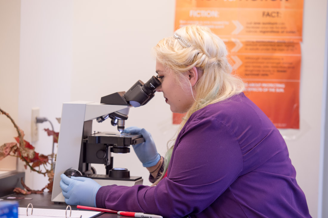Dermatopathologist observing through a microscope